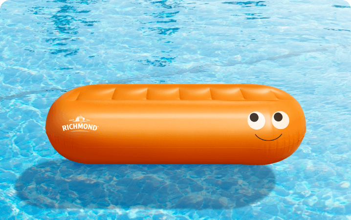 A Richmond-branded sausage-shaped inflatable lilo floating in a swimming pool, one of the 250 available prizes.